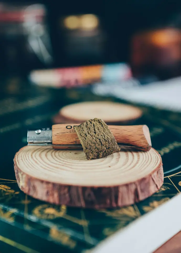 A piece of wood with a knife on top of it